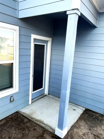 a view of a yard with wooden fence