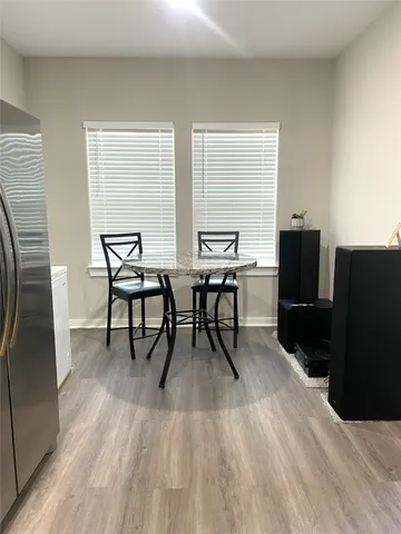 a dining room with furniture and wooden floor