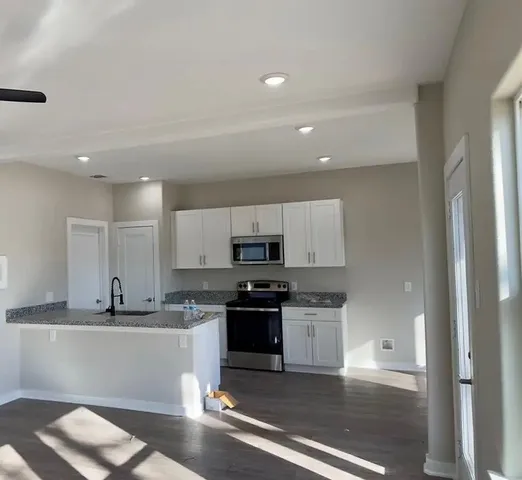 a kitchen with stainless steel appliances granite countertop a sink and cabinets