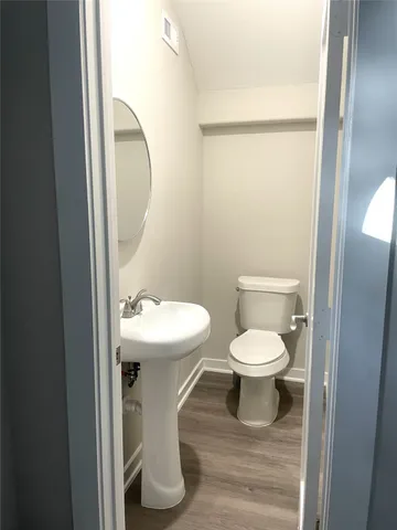 a white toilet sitting next to a bathroom sink
