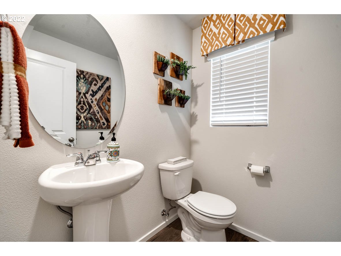2648 26th Loop Springfield, OR 97477 - Photo 9 of 18 a bathroom with a toilet sink and mirror