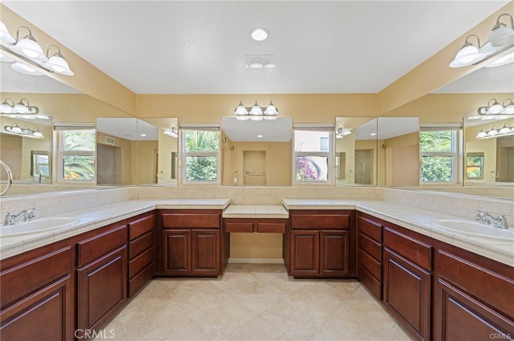 8634 Hunt Canyon Road Corona, CA 92883 - Photo 18 of 31 a spacious bathroom with double vanity and a large mirror