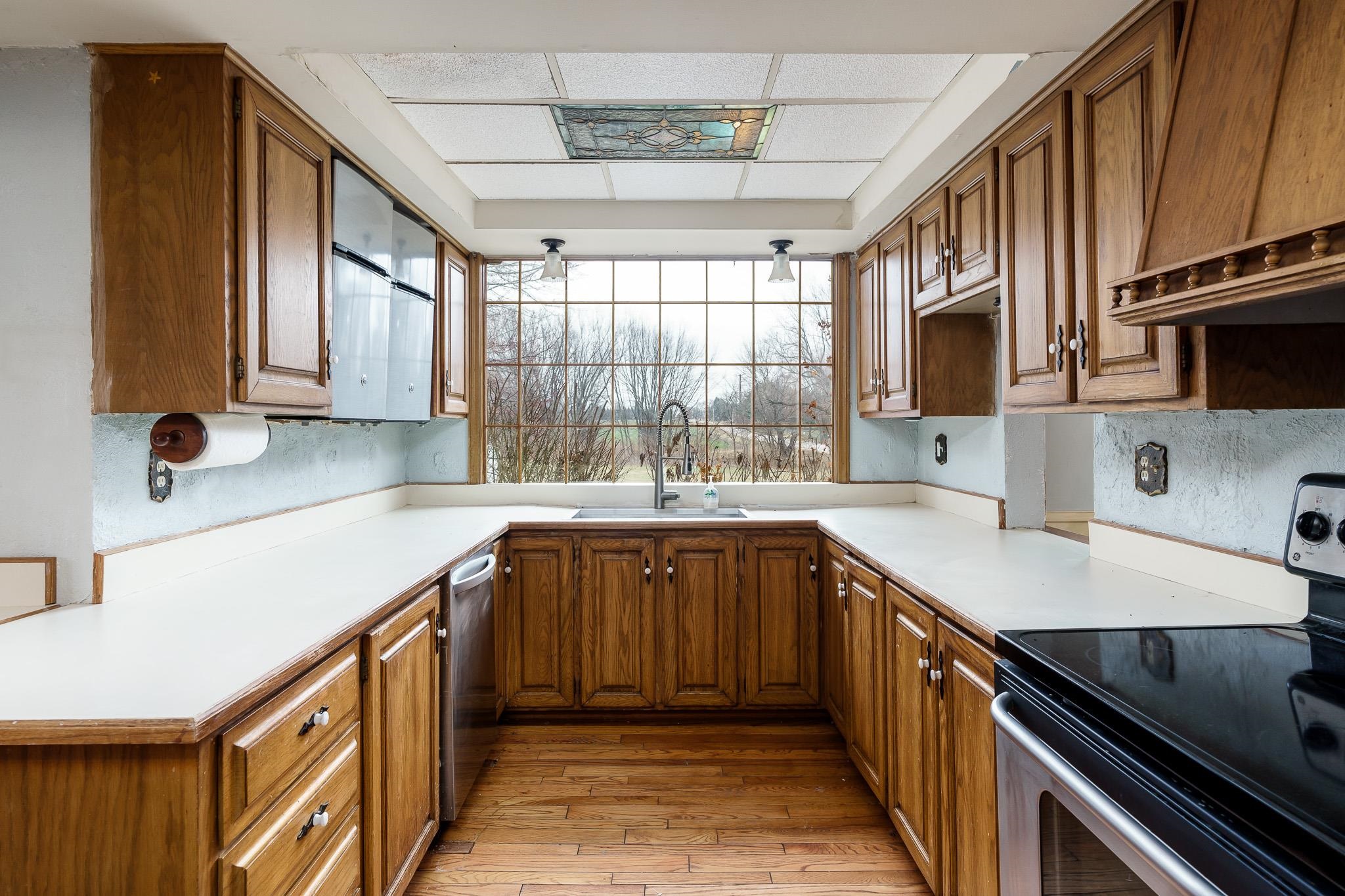 2826 Orth Road Belvidere, IL 61008 - Photo 22 of 43 a kitchen with stainless steel appliances granite countertop a sink stove and cabinets