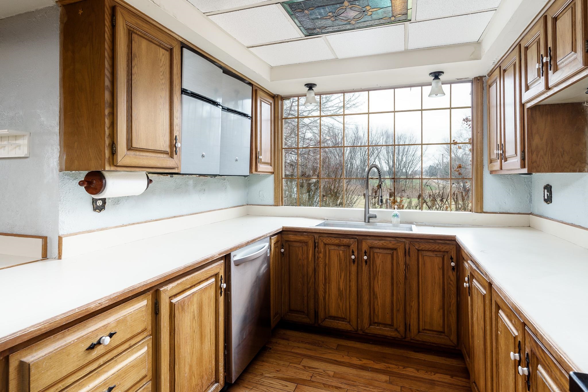 2826 Orth Road Belvidere, IL 61008 - Photo 23 of 43 a kitchen with a sink a window and cabinets