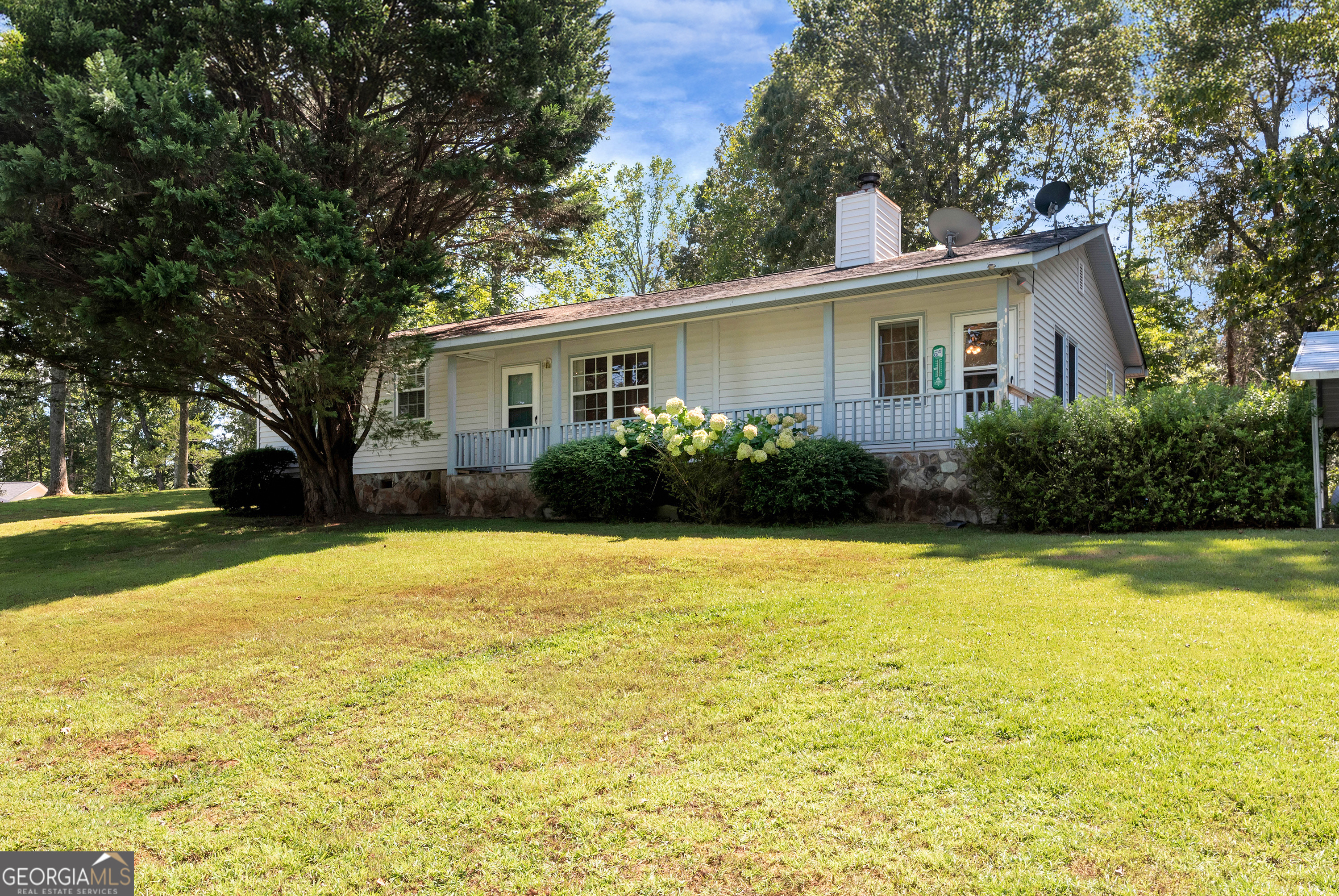 303 Jennys Cove Road Cleveland, GA 30528 - Photo 1 of 60 a view of a house with pool and a garden