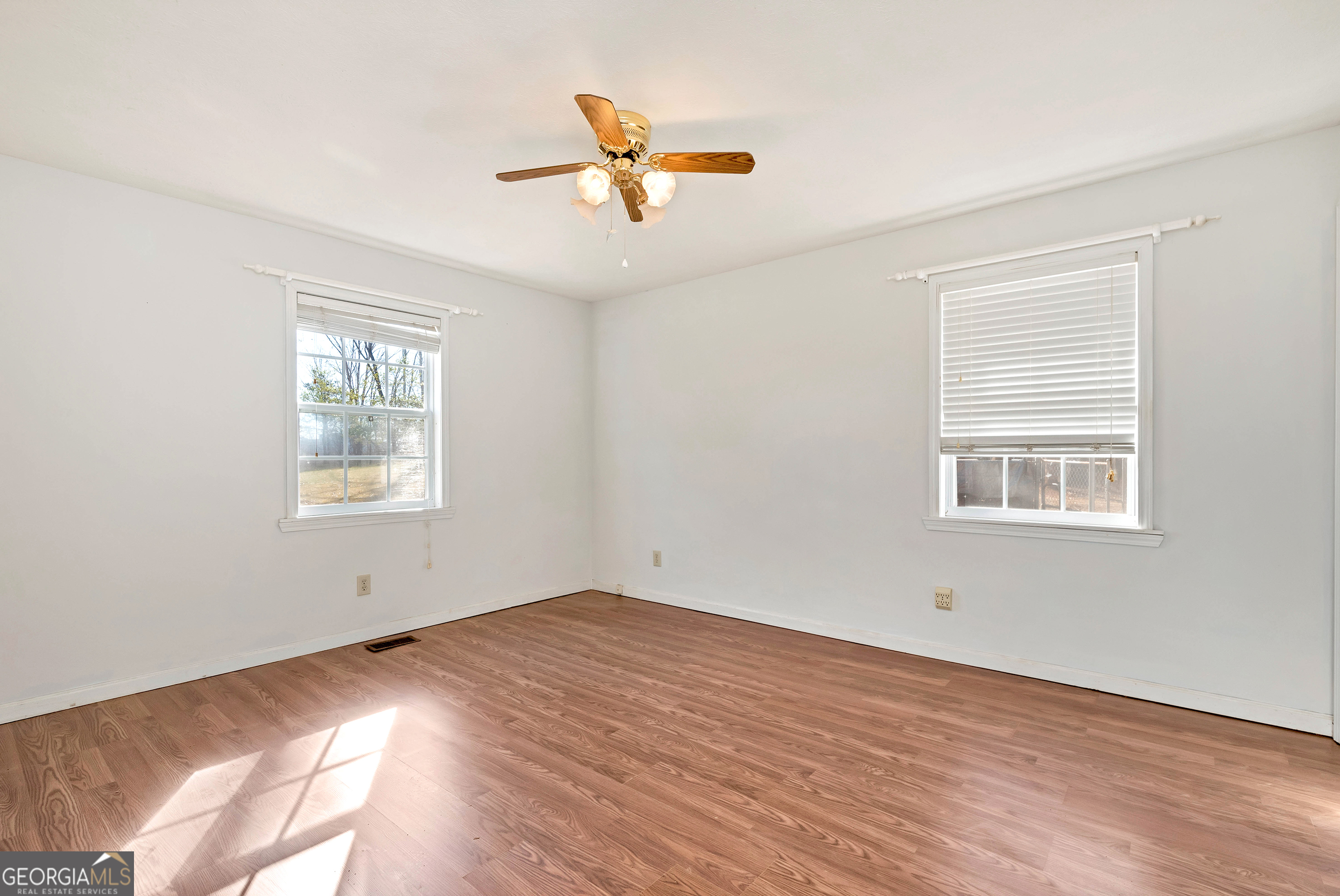 303 Jennys Cove Road Cleveland, GA 30528 - Photo 14 of 60 a view of empty room with wooden floor and fan