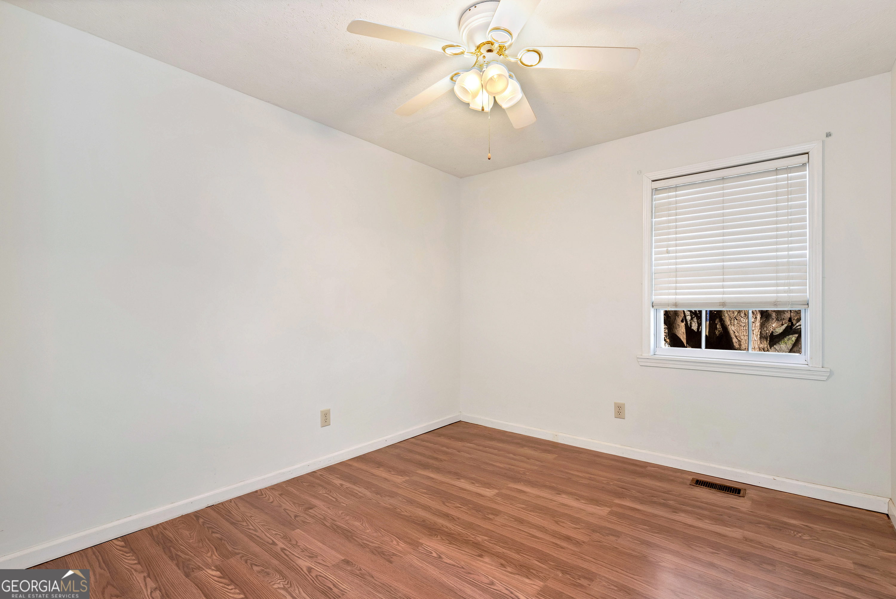 303 Jennys Cove Road Cleveland, GA 30528 - Photo 19 of 60 wooden floor in an empty room with a window
