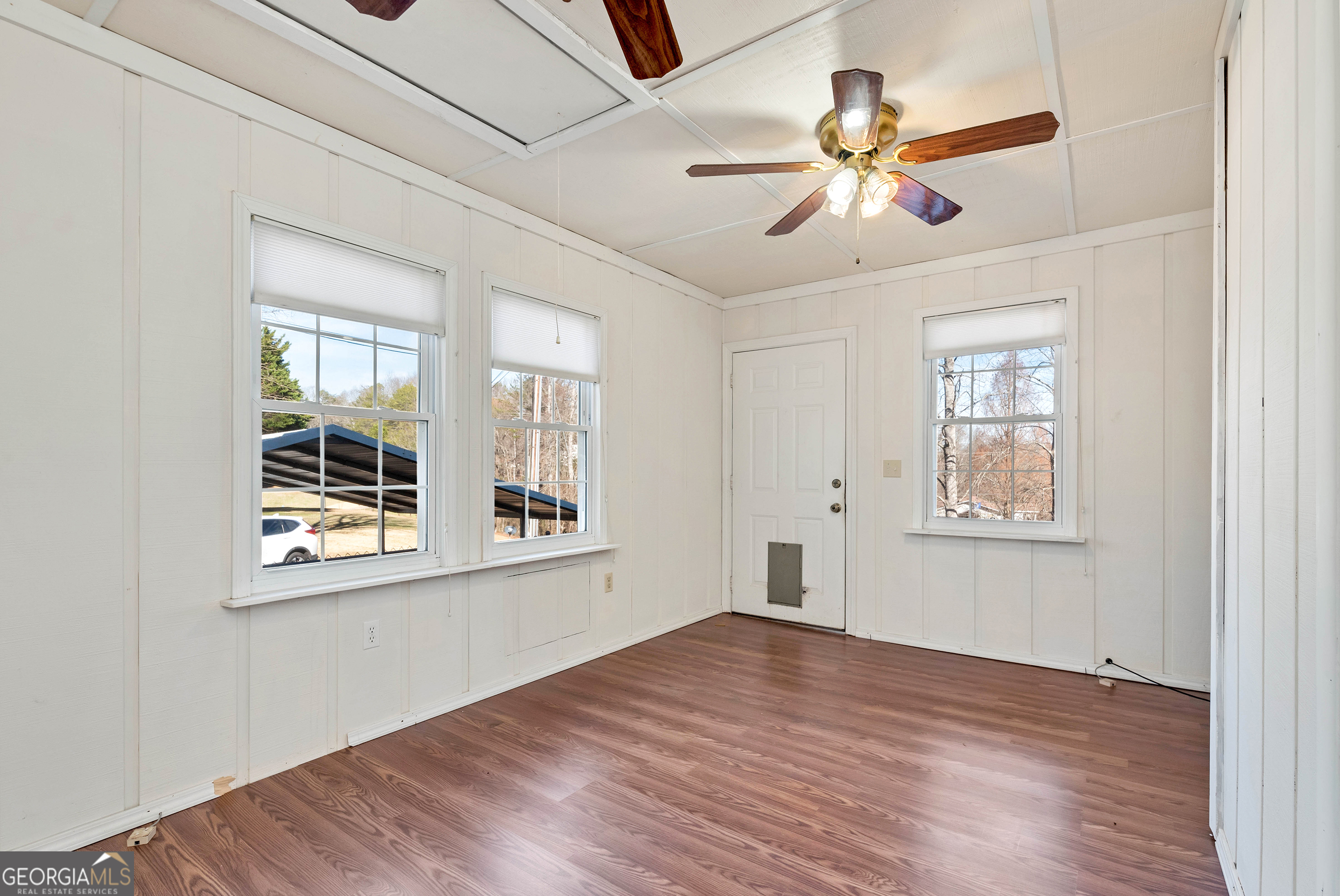 303 Jennys Cove Road Cleveland, GA 30528 - Photo 21 of 60 a view of an empty room with wooden floor and a window