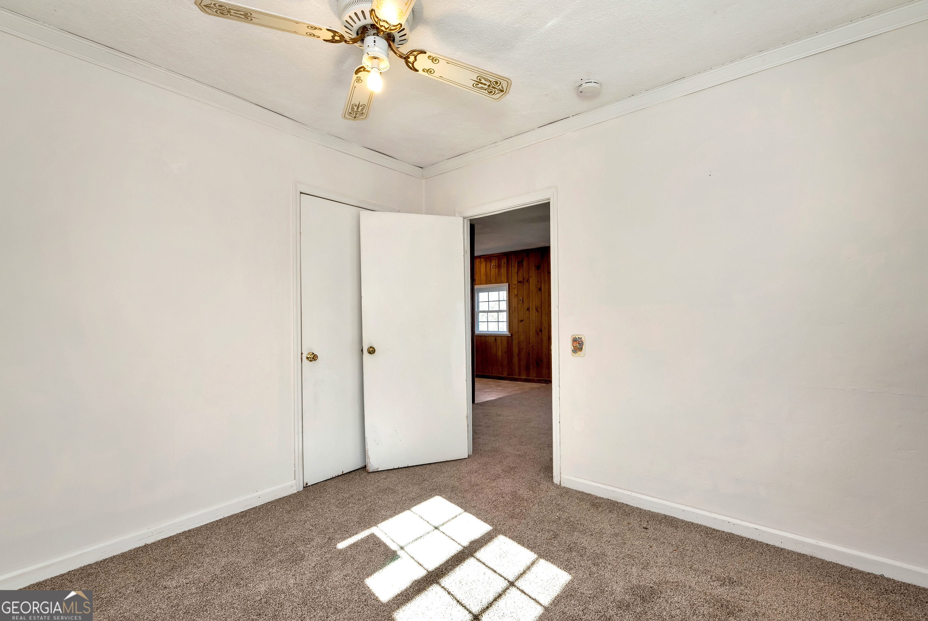 303 Jennys Cove Road Cleveland, GA 30528 - Photo 43 of 60 en empty room with windows and ceiling fan