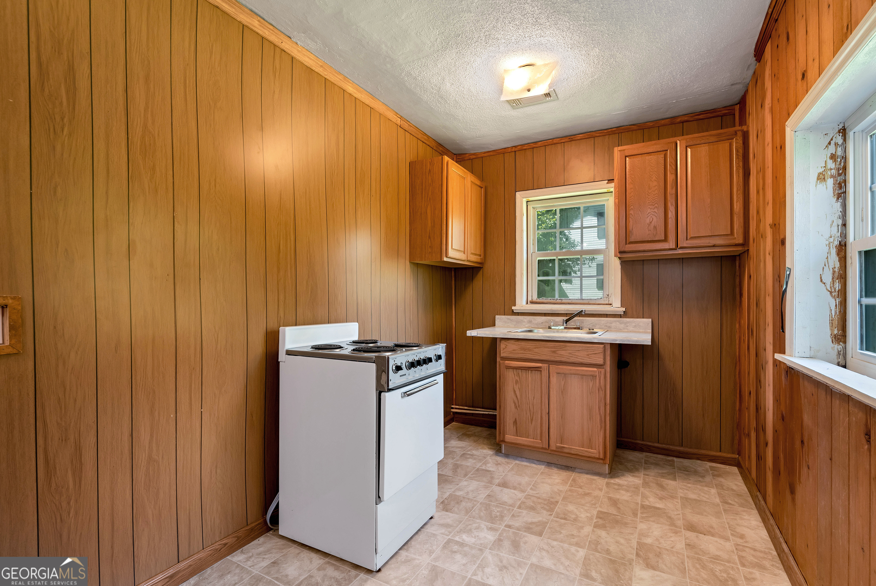 303 Jennys Cove Road Cleveland, GA 30528 - Photo 44 of 60 a kitchen with a stove a sink and a microwave