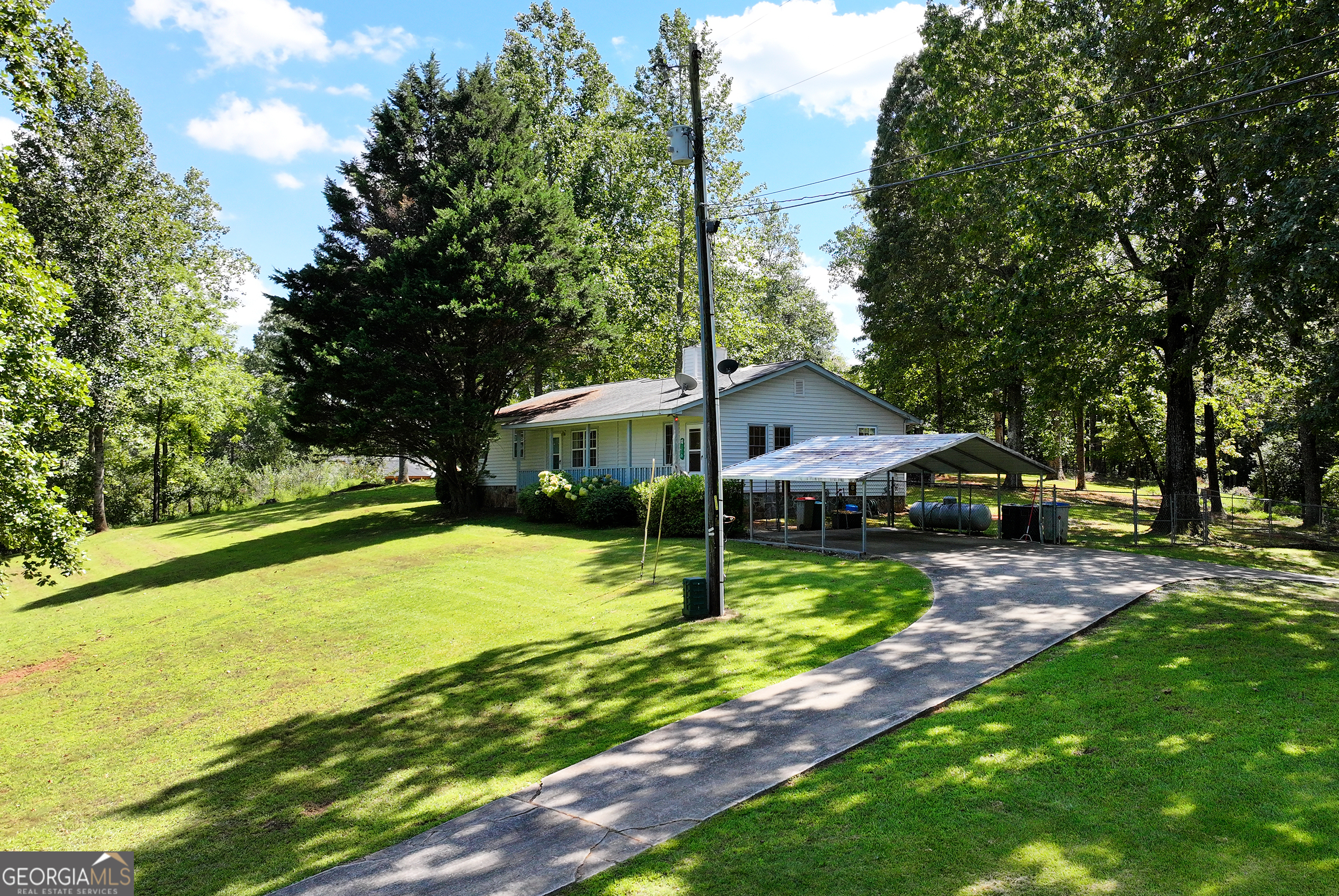 303 Jennys Cove Road Cleveland, GA 30528 - Photo 46 of 60 a view of a house with backyard and sitting area