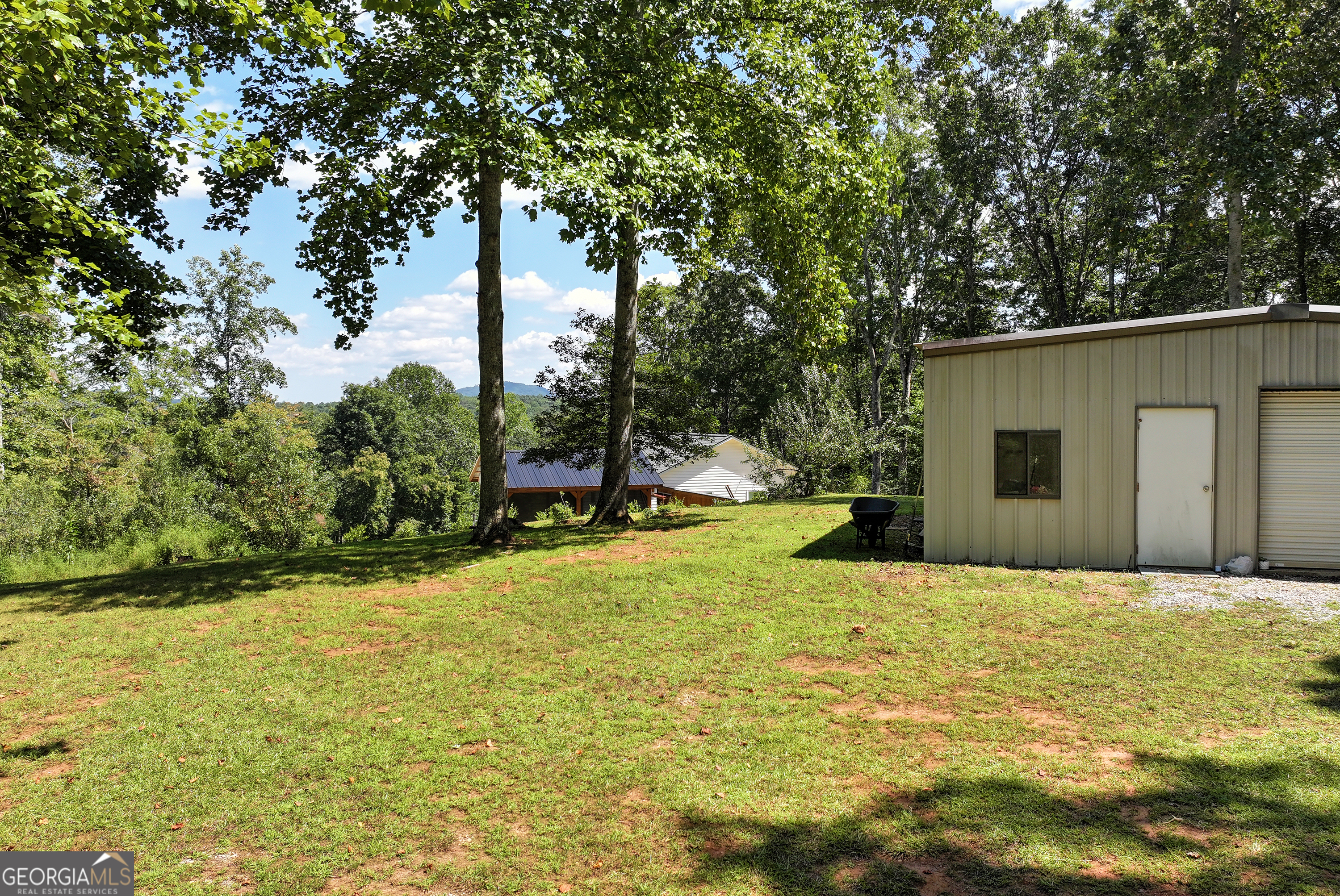 303 Jennys Cove Road Cleveland, GA 30528 - Photo 49 of 60 a view of a swimming pool with a patio and a yard
