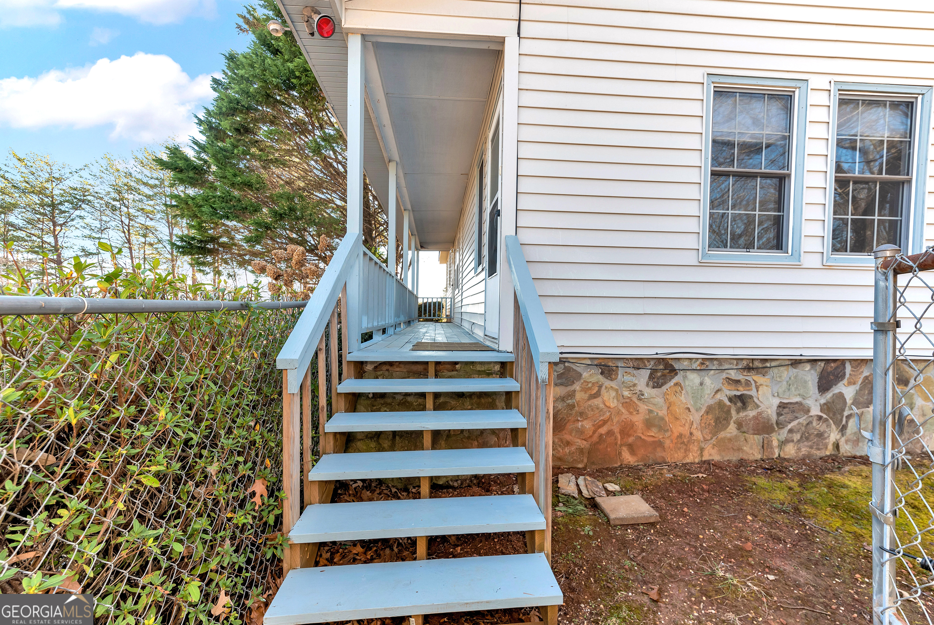 303 Jennys Cove Road Cleveland, GA 30528 - Photo 5 of 60 a view of a balcony with plants and wooden floor