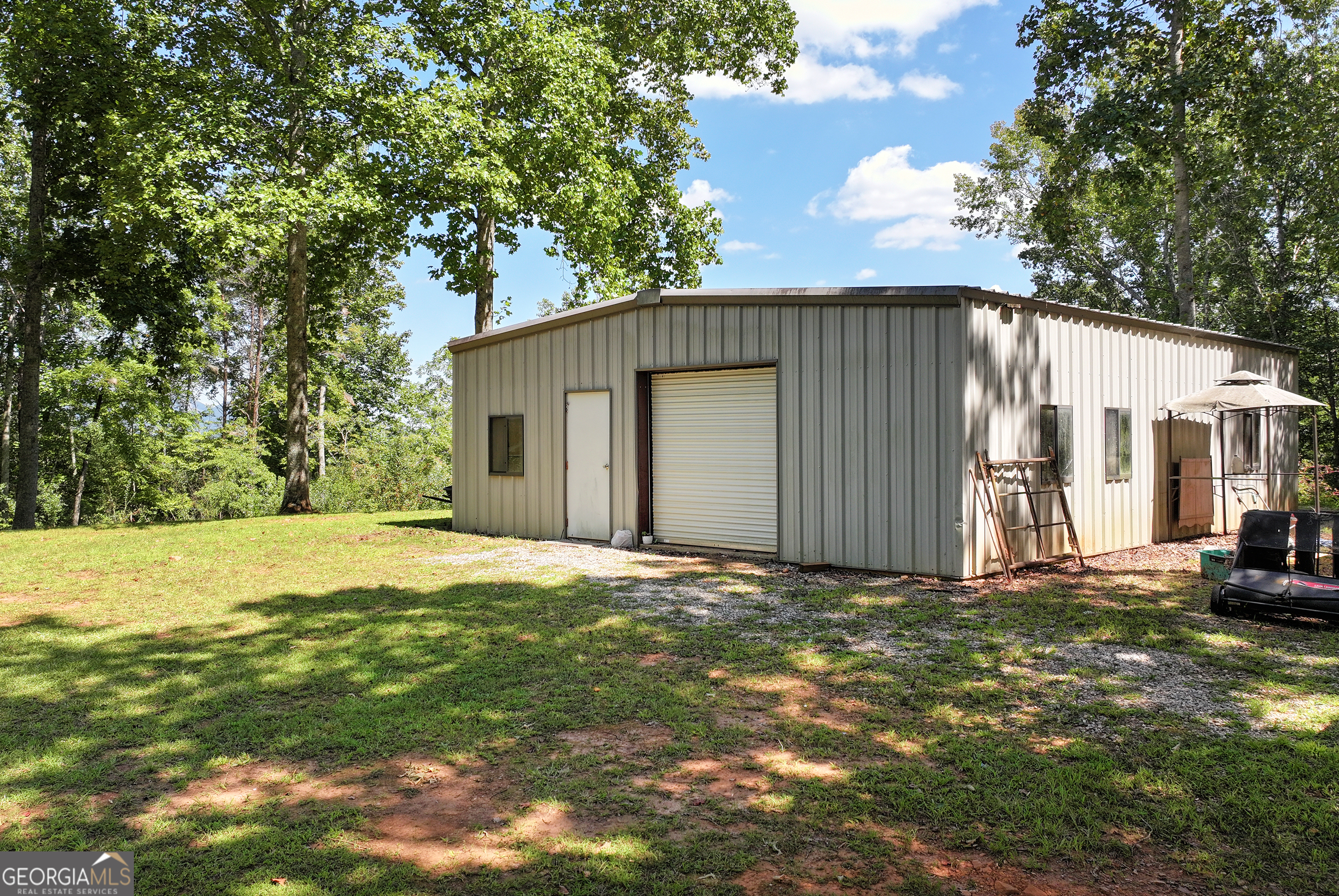 303 Jennys Cove Road Cleveland, GA 30528 - Photo 51 of 60 a view of a house with backyard and trees
