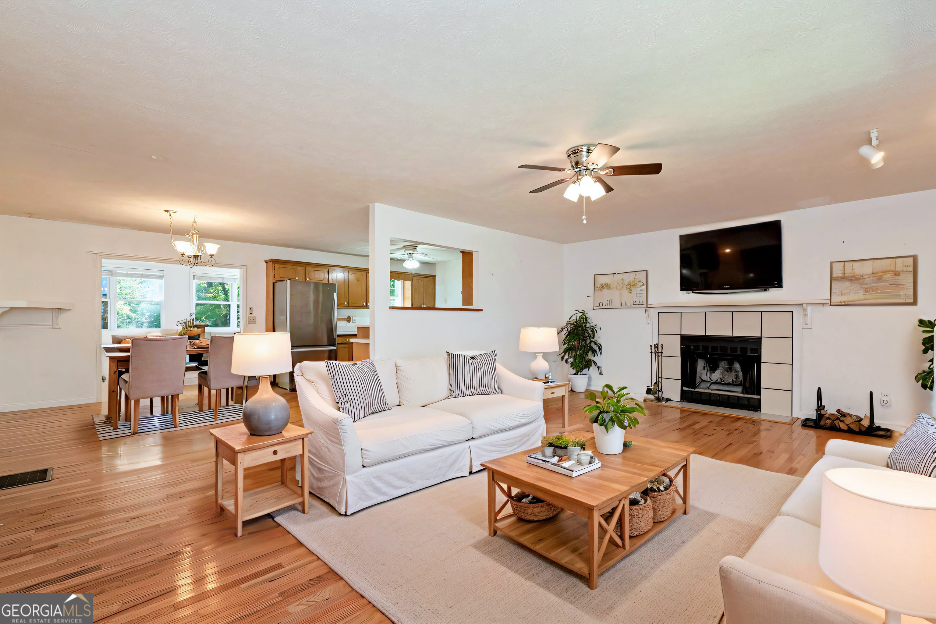 303 Jennys Cove Road Cleveland, GA 30528 - Photo 6 of 60 a living room with furniture a fireplace and a flat screen tv