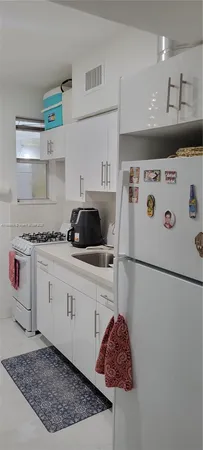 a utility room with cabinets washer and dryer
