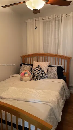 a bed sitting in a bedroom next to a cabinet