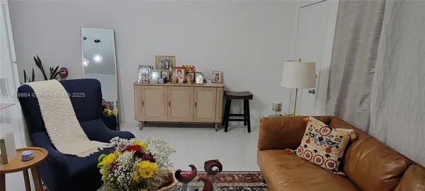 a bedroom with furniture and a wooden floor