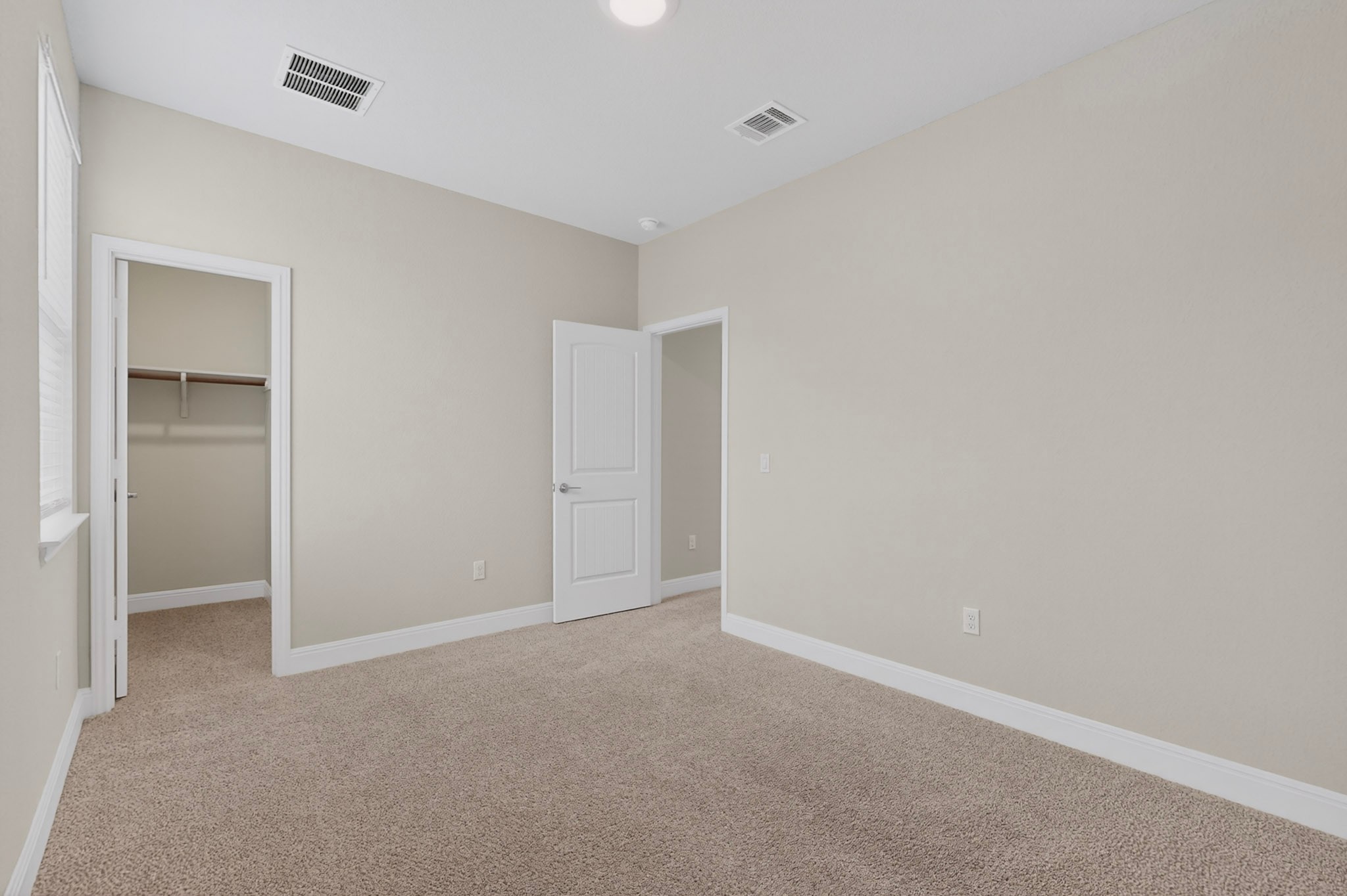 16809 Guido Cove Pflugerville, TX 78660 - Photo 31 of 40 Spacious room featuring neutral carpeting, light-colored walls, and a white trim package