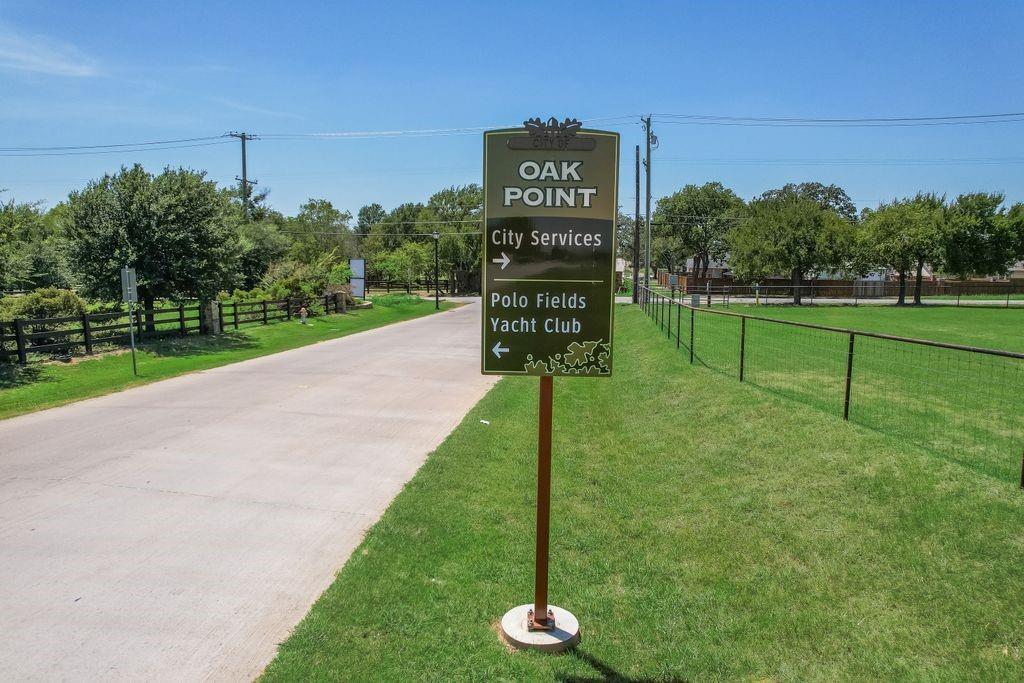 521 Martingale Trail Oak Point, TX 75068 - Photo 31 of 36 a sign board with a play ground in the back