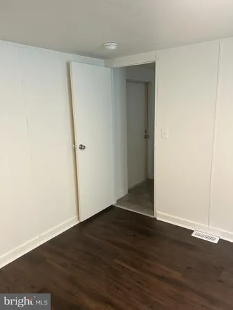 an empty room with wooden floor