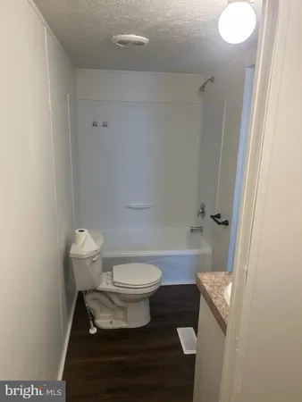 a bathroom with a toilet a sink and a bathtub