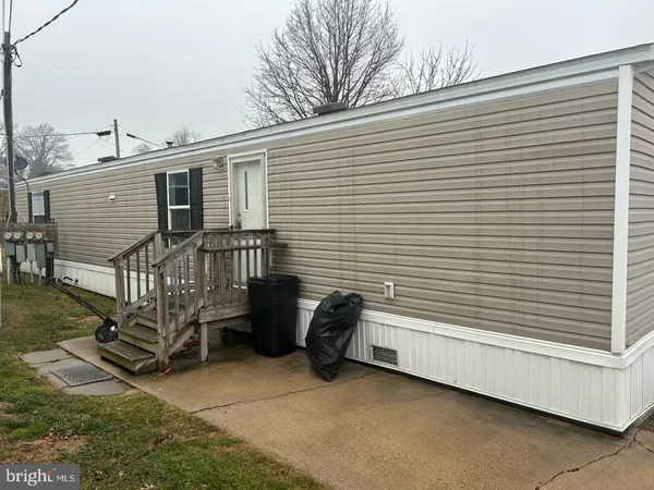 a view of a chair and bench in the backyard