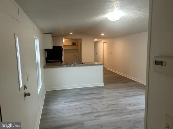 a view of a kitchen with a sink and a refrigerator