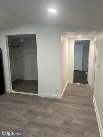 a view of hallway with wooden floor