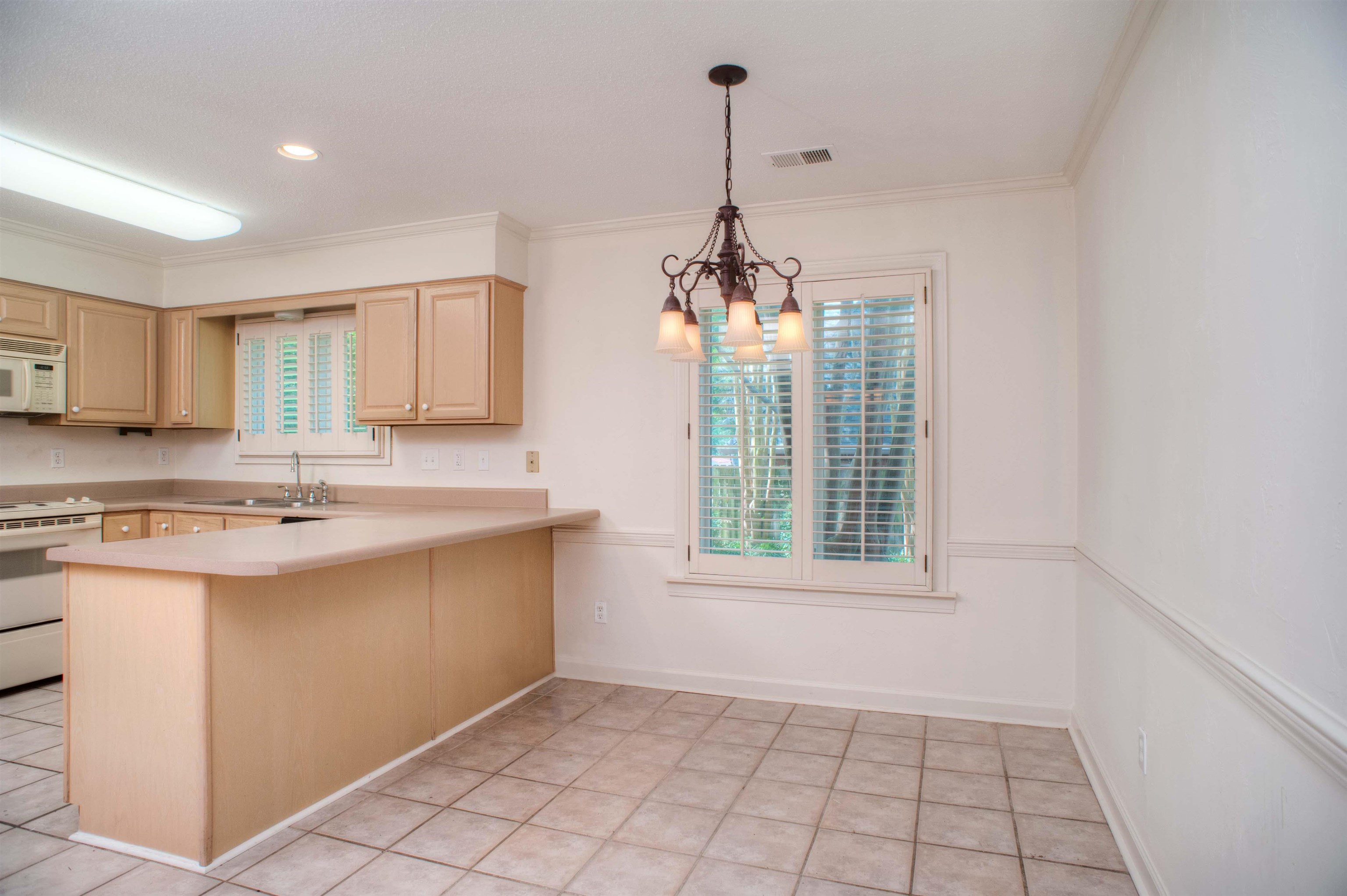 8225 Walnut Grove Road Memphis, TN 38018 - Photo 12 of 29 a view of a kitchen with a sink cabinets and a window