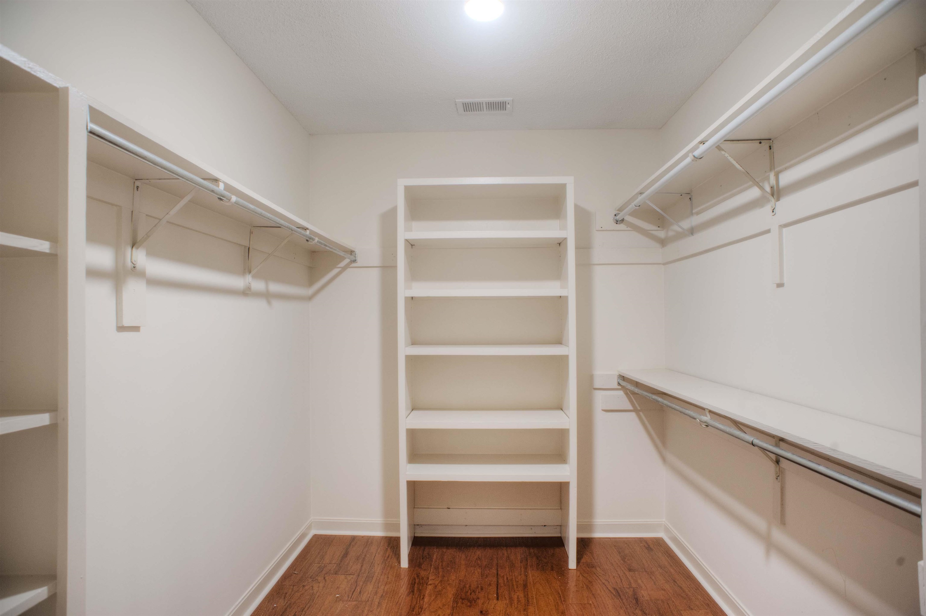 8225 Walnut Grove Road Memphis, TN 38018 - Photo 16 of 29 a view of walk in closet with empty racks