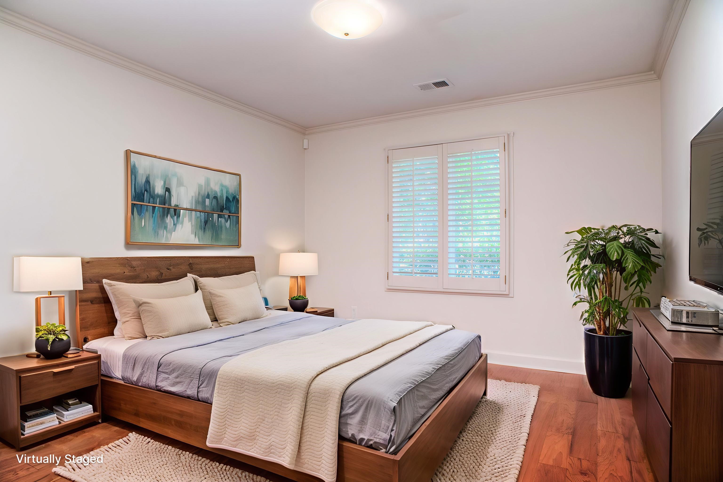 8225 Walnut Grove Road Memphis, TN 38018 - Photo 21 of 29 a bedroom with bed and a potted plant