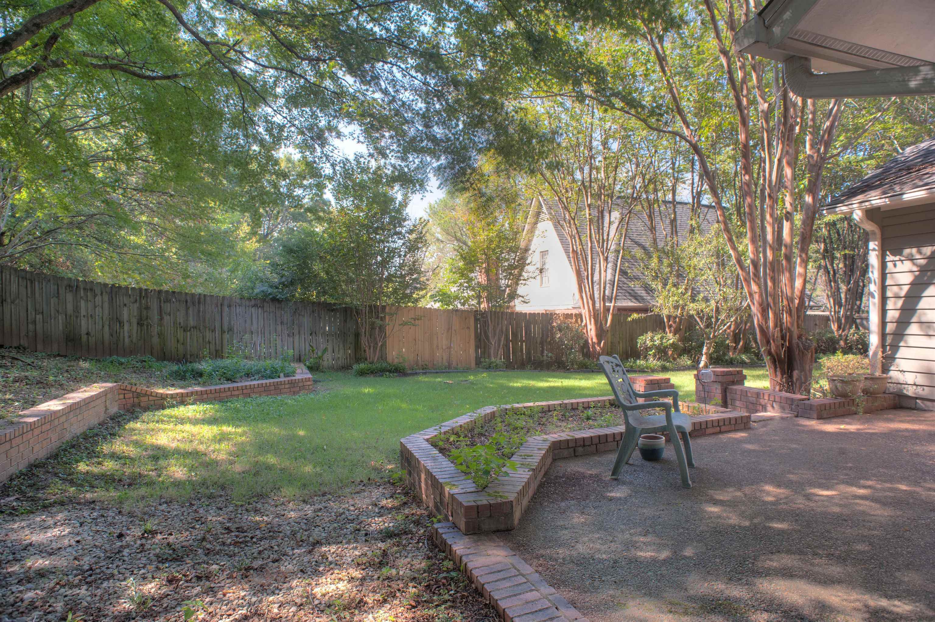 8225 Walnut Grove Road Memphis, TN 38018 - Photo 28 of 29 a view of a backyard with table and chairs and a slide