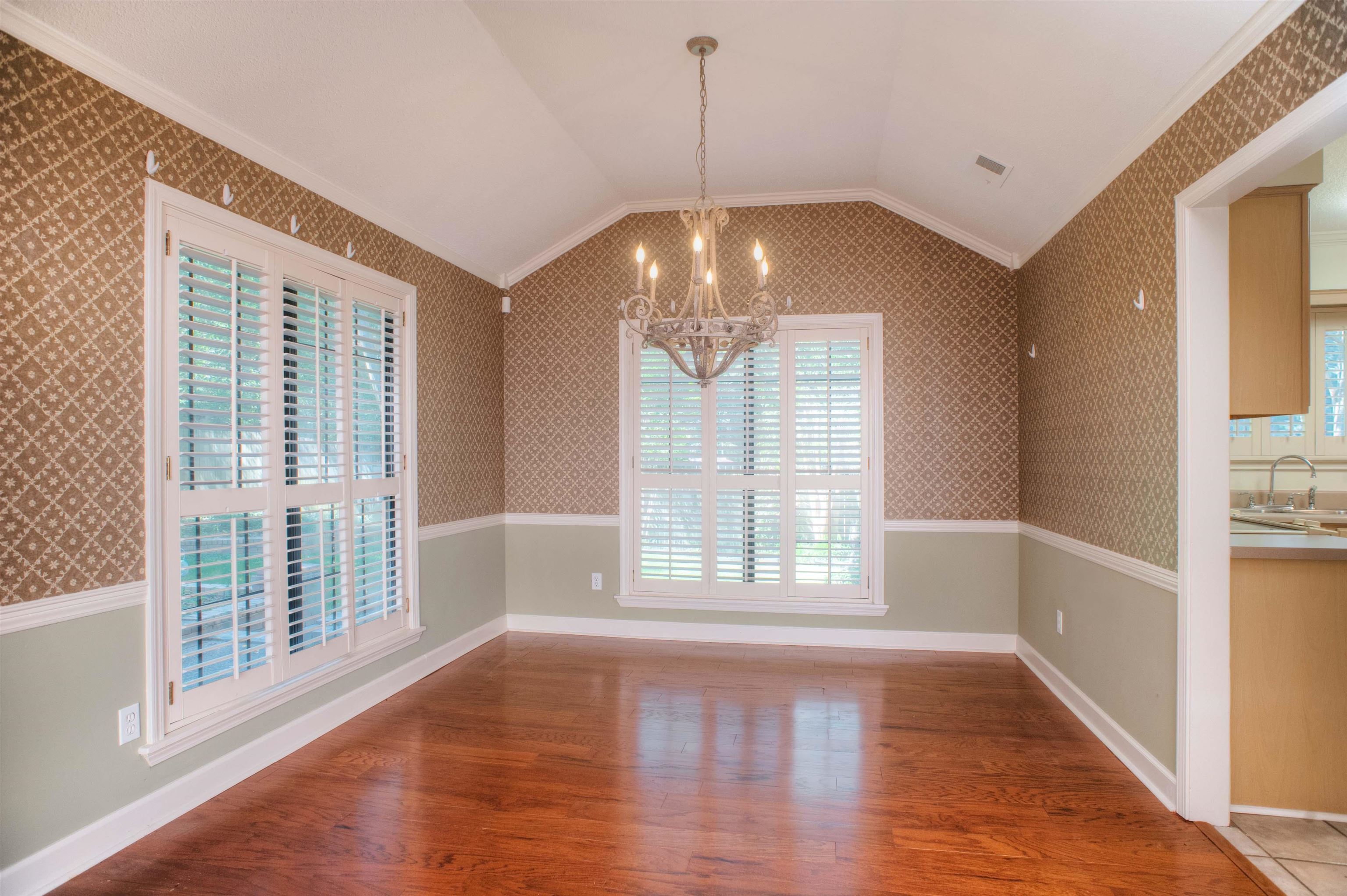 8225 Walnut Grove Road Memphis, TN 38018 - Photo 4 of 29 a view of an empty room with wooden floor and a window