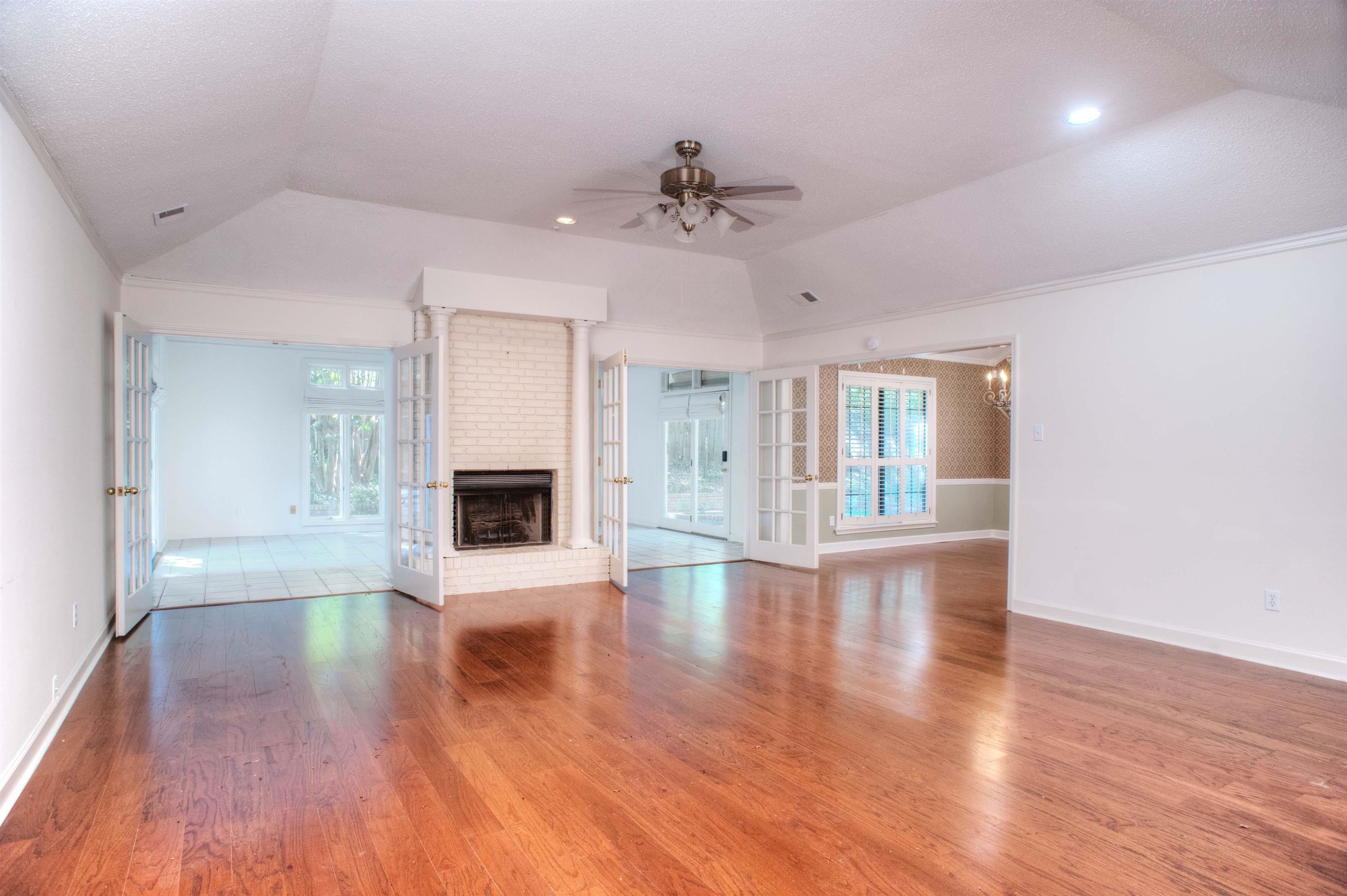 8225 Walnut Grove Road Memphis, TN 38018 - Photo 6 of 29 a view of an empty room with wooden floor and a window