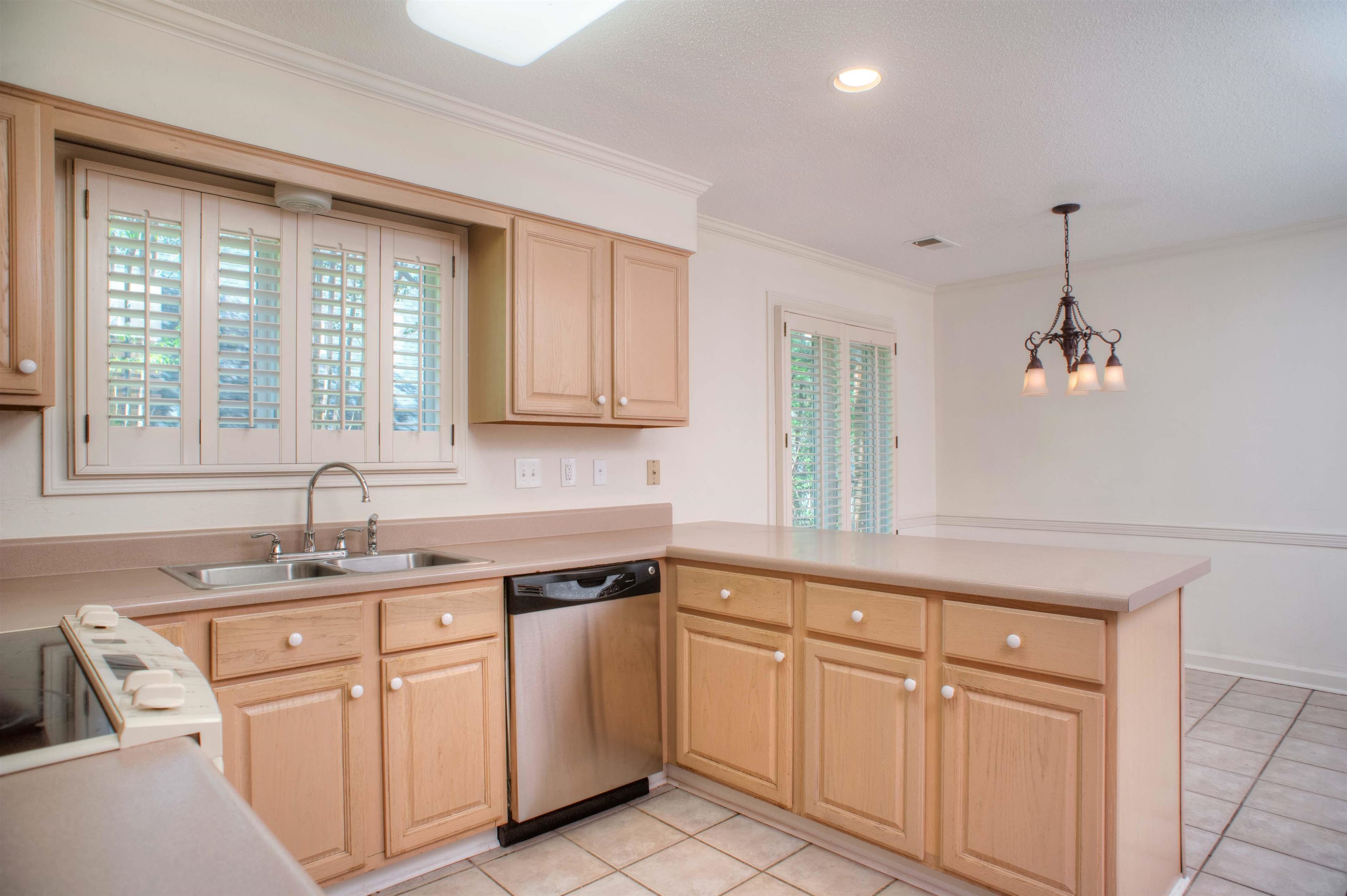 8225 Walnut Grove Road Memphis, TN 38018 - Photo 10 of 29 a kitchen with white cabinets and white appliances