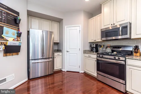 a kitchen with stainless steel appliances a refrigerator stove and microwave