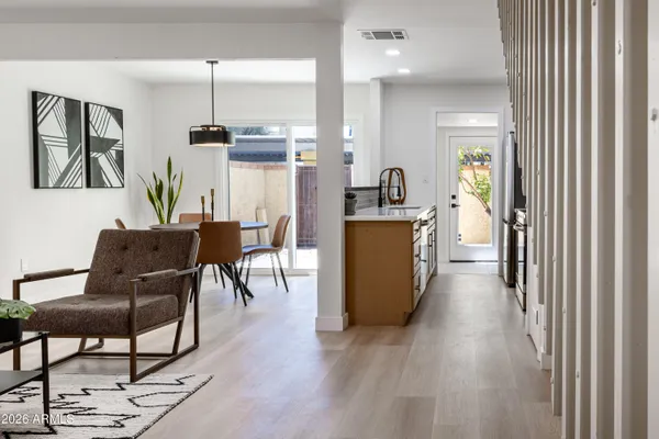 a view of a kitchen with furniture and wooden floor