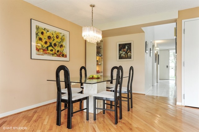 182 Wellington Road Northbrook, IL 60062 - Photo 8 of 22 a view of a dining room with furniture wooden floor and a chandelier