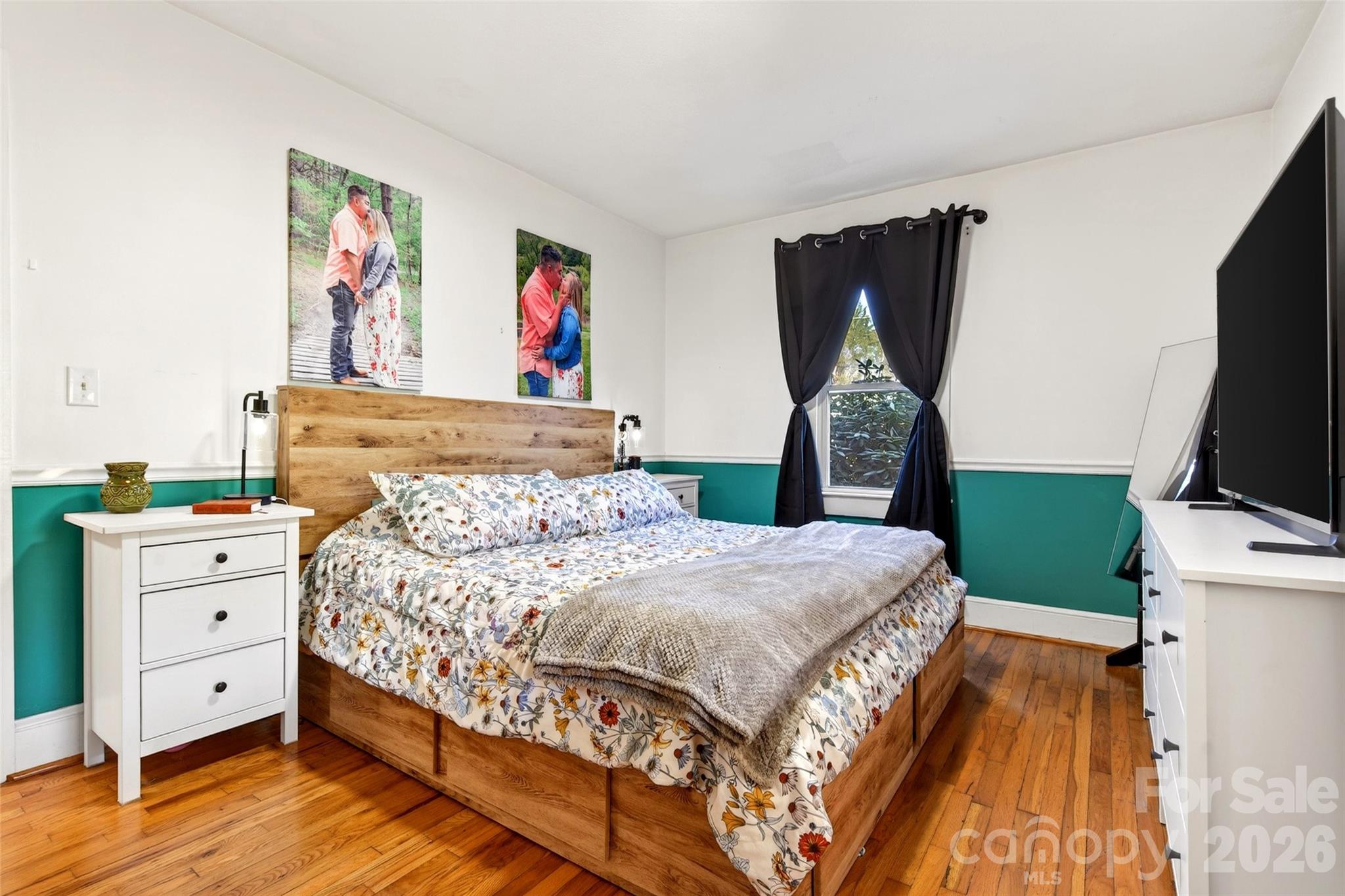 1511 White Oak Road Bakersville, NC 28705 - Photo 14 of 33 a bedroom with a bed and a flat tv screen on dresser