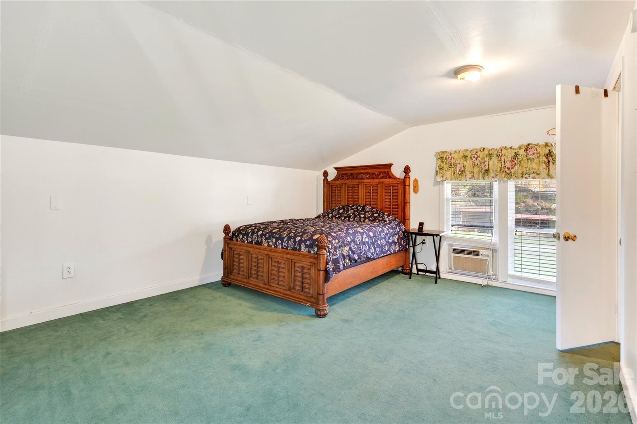 1511 White Oak Road Bakersville, NC 28705 - Photo 22 of 33 a room with a bed and a night stand in it