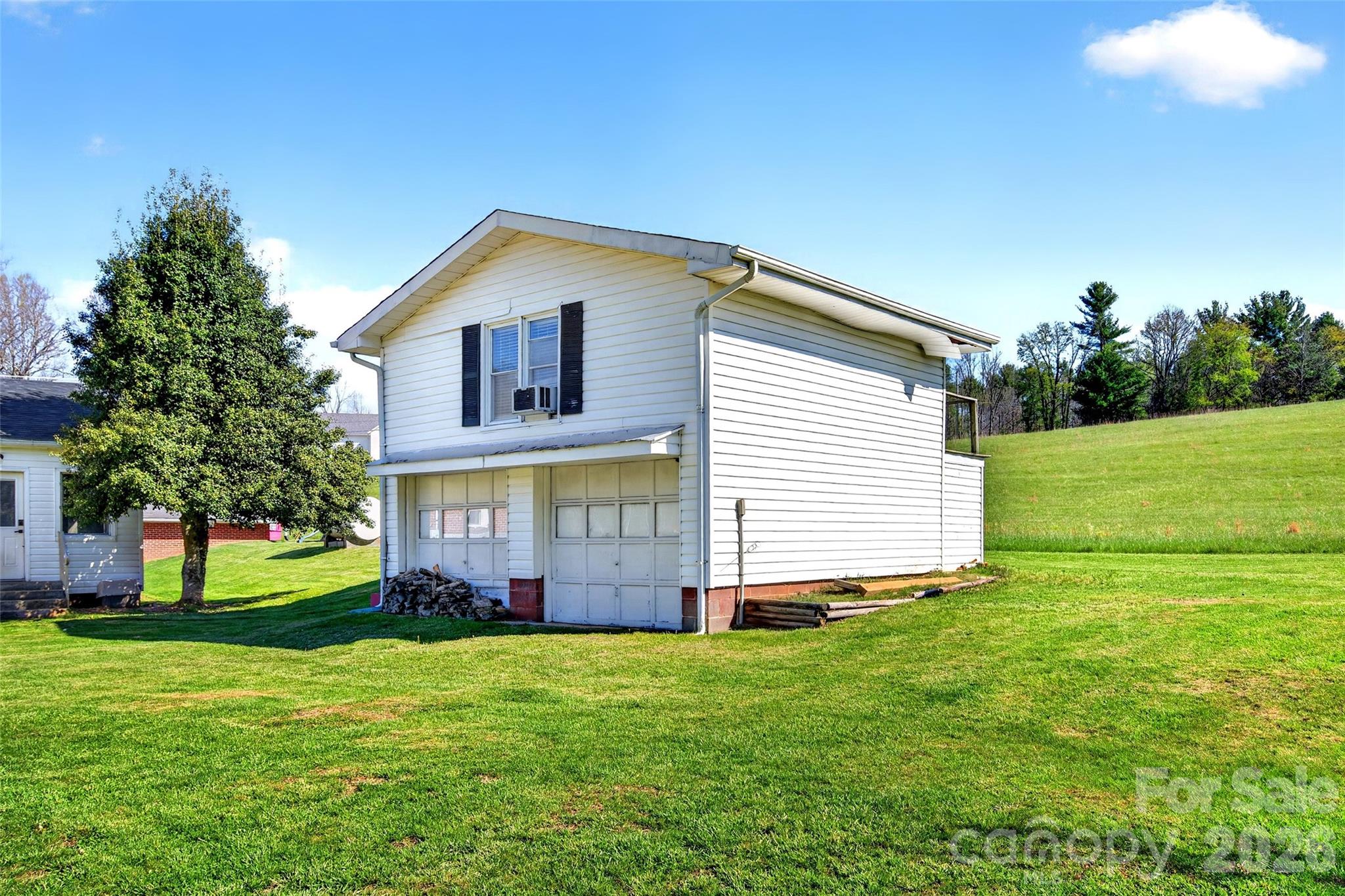 1511 White Oak Road Bakersville, NC 28705 - Photo 29 of 33 a view of a house with a big yard and large trees