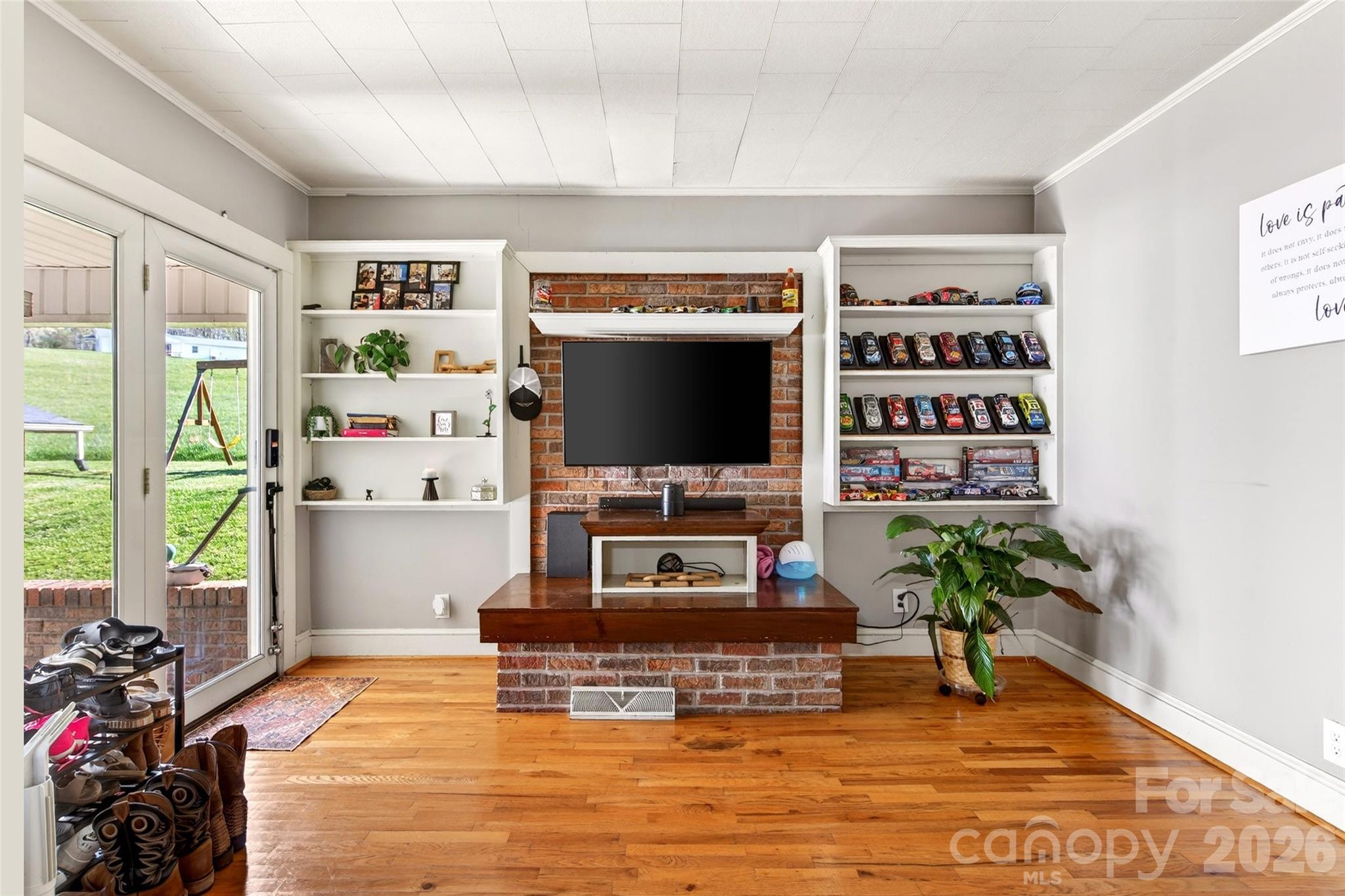 1511 White Oak Road Bakersville, NC 28705 - Photo 4 of 33 a living room with furniture a flat screen tv and a floor to ceiling window