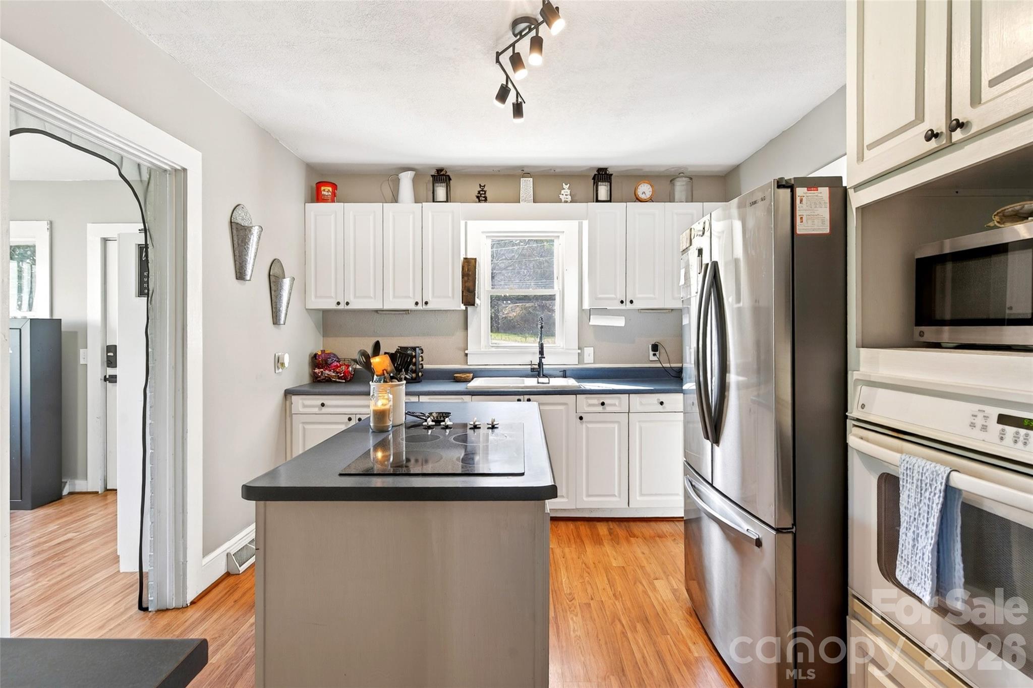 1511 White Oak Road Bakersville, NC 28705 - Photo 7 of 33 a kitchen with granite countertop a refrigerator stove and sink