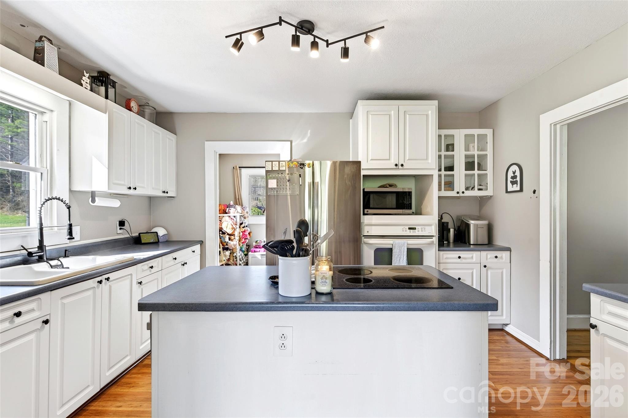 1511 White Oak Road Bakersville, NC 28705 - Photo 9 of 33 a kitchen with stainless steel appliances granite countertop a sink refrigerator and cabinets