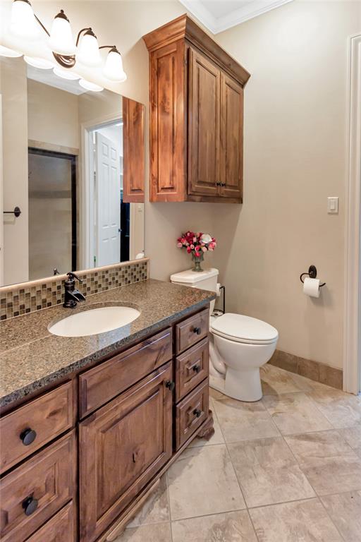 8350 FM 346 Flint, TX 75762 - Photo 14 of 39 a bathroom with a granite countertop toilet sink and mirror