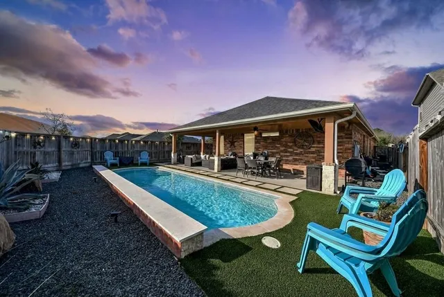 a view of a house with backyard porch and sitting area