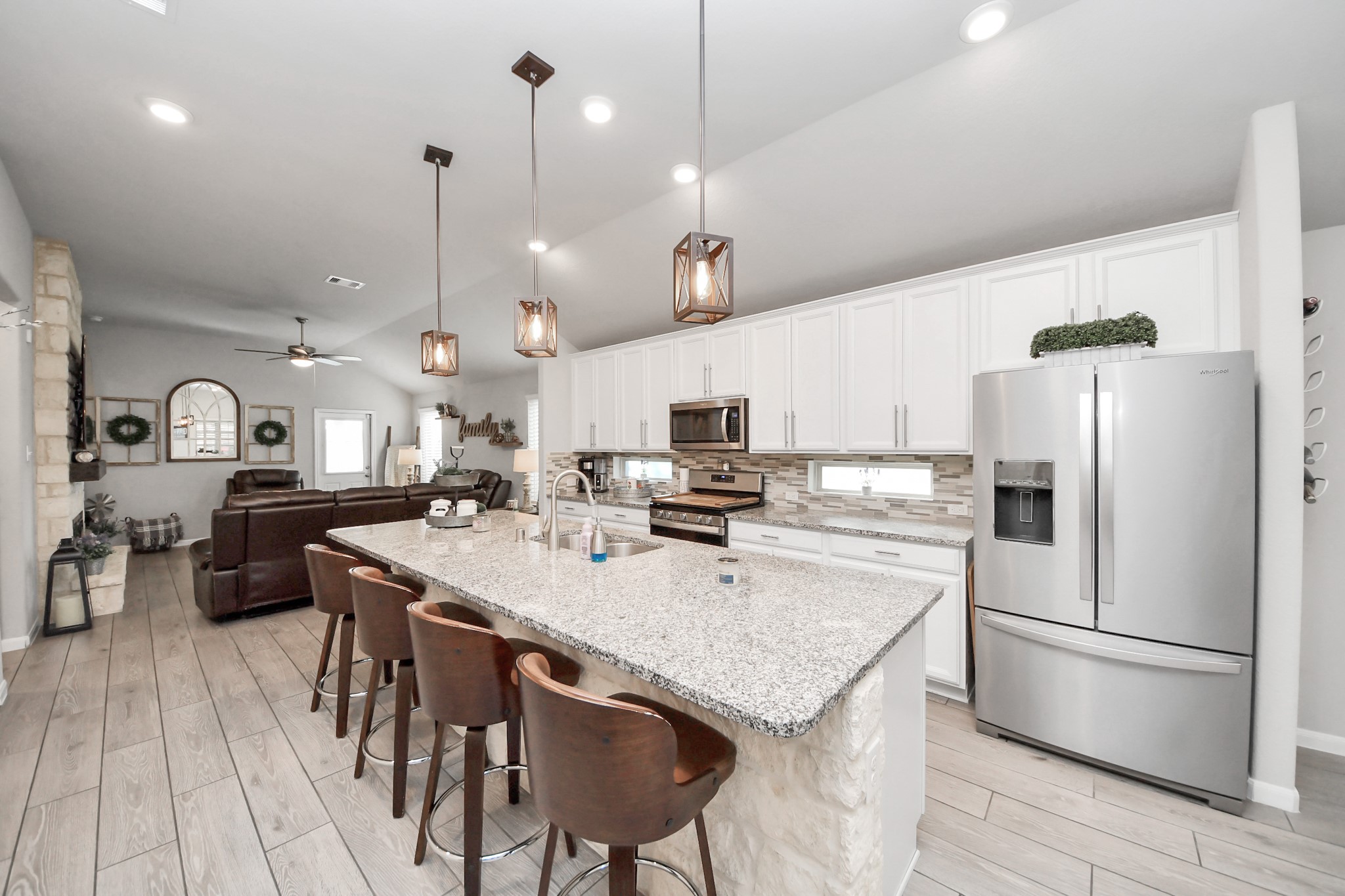 550 Winburn Tide Lane La Porte, TX 77571 - Photo 12 of 40 a kitchen with stainless steel appliances granite countertop a sink a stove a refrigerator and island with wooden floor