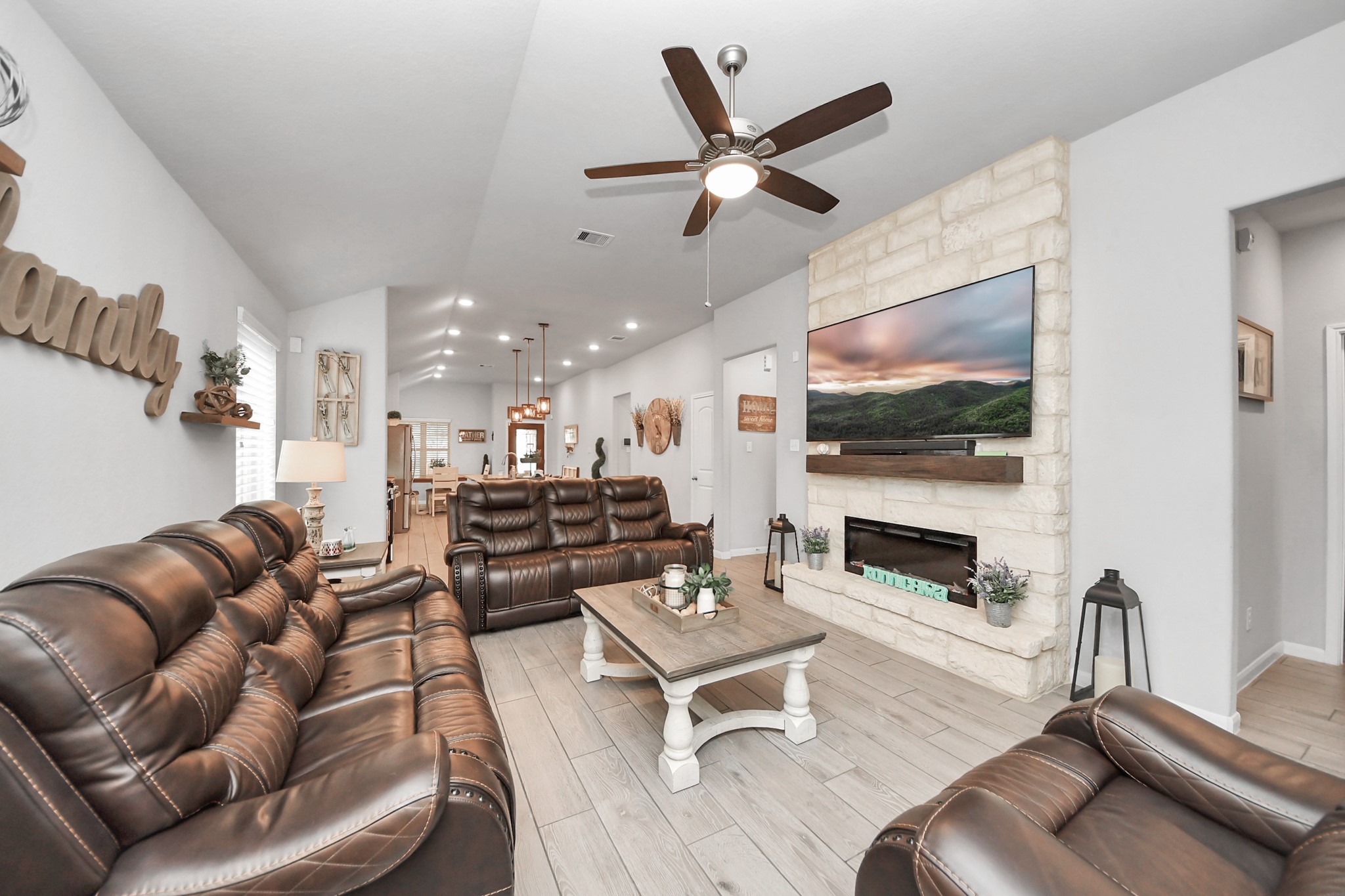 550 Winburn Tide Lane La Porte, TX 77571 - Photo 15 of 40 a living room with furniture kitchen view and a fireplace