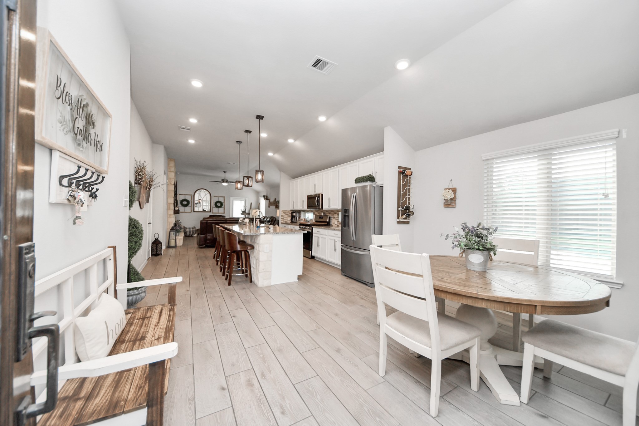 550 Winburn Tide Lane La Porte, TX 77571 - Photo 6 of 40 a kitchen with stainless steel appliances kitchen island granite countertop a table chairs and a refrigerator
